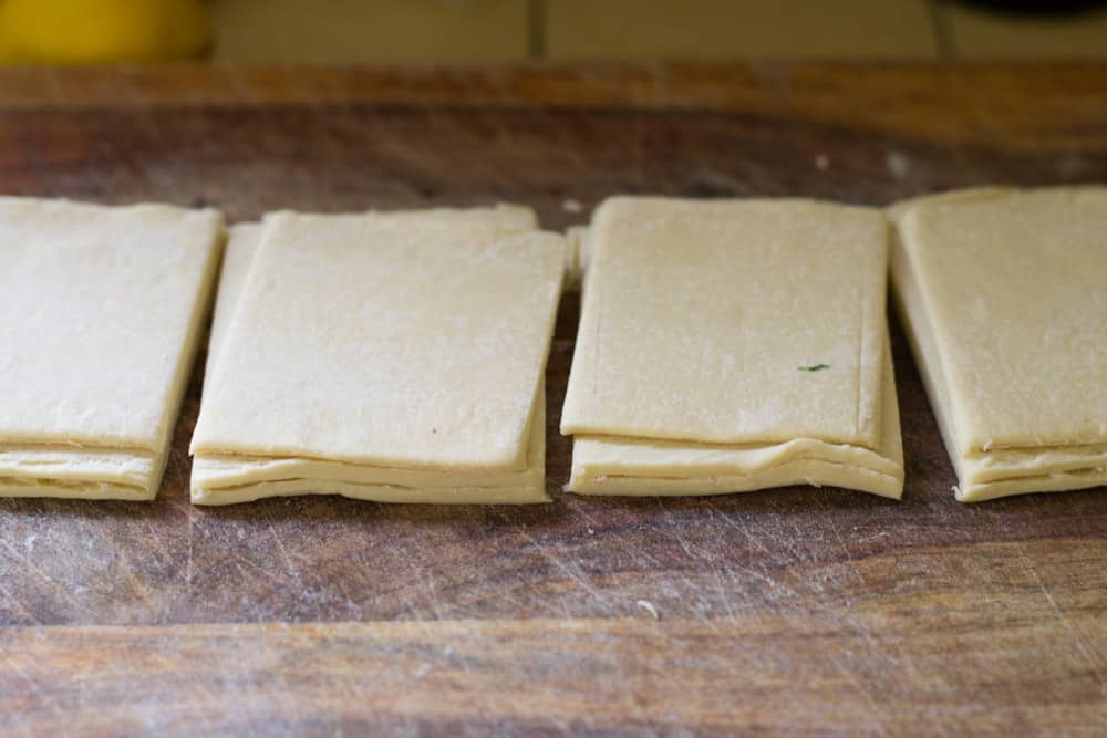 To make mini puff pastry bites, cut puff pastry into 3 long strips then into 12 squares.
