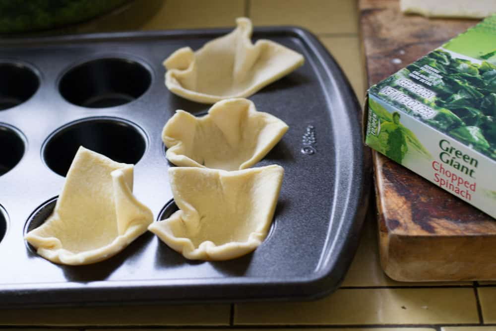 Take each puff pastry square and place it into your mini muffin tin.