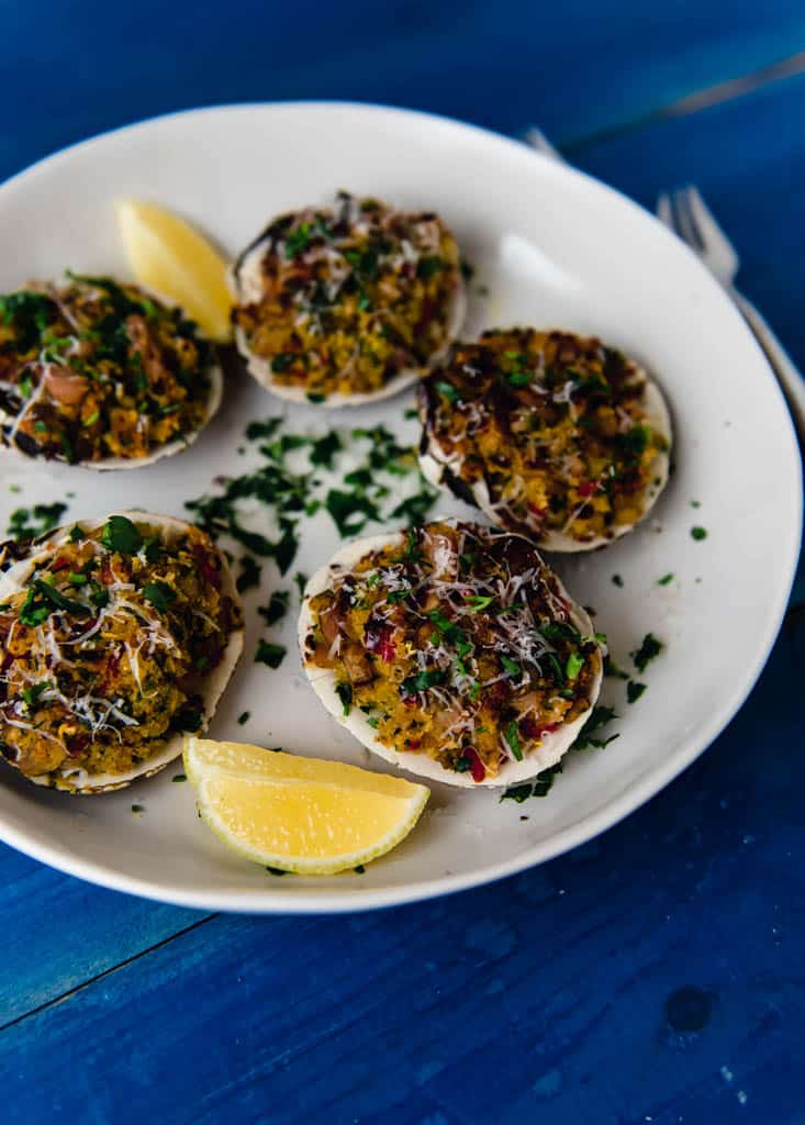 Baked clams casino are steamed clams that are stuffed with a mixture of shallots, peppers, panko and Parmesan cheese.