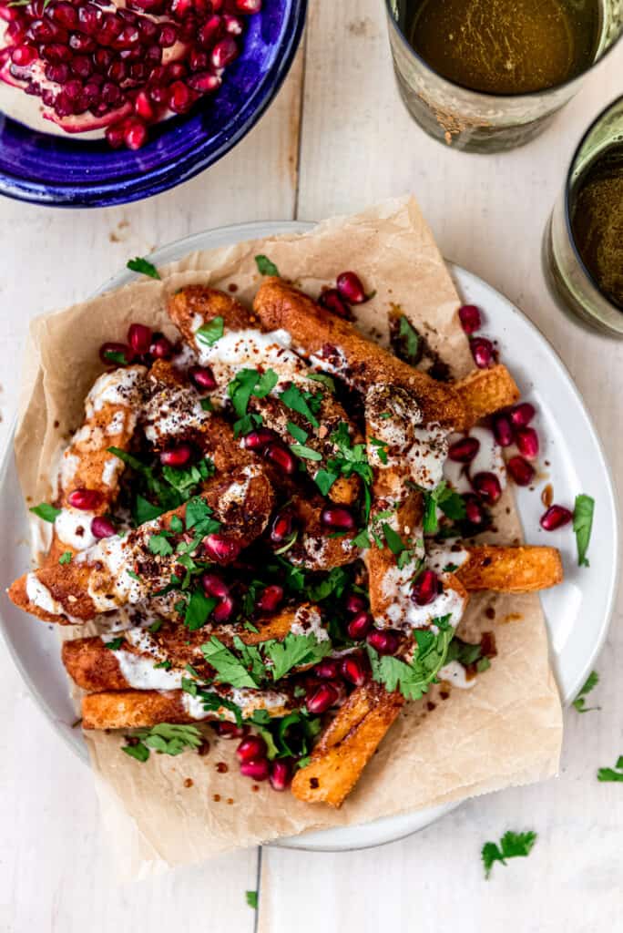 Halloumi fries are gently fried to a golden brown and crispy and topped with creamy yogurt, pomegranate molasses and zaatar.