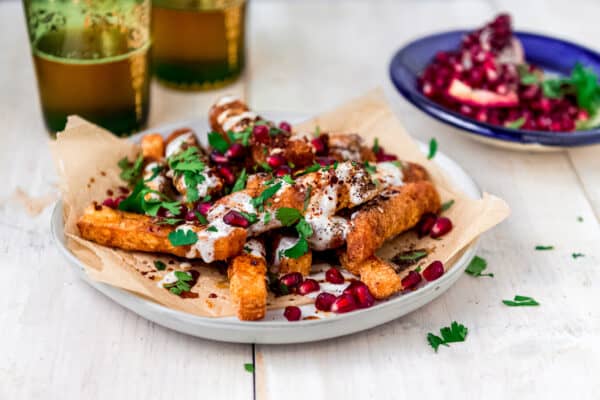 Perfectly golden halloumi fries are topped with creamy yogurt, pomegranate molasses and zaatar making them irresistible.