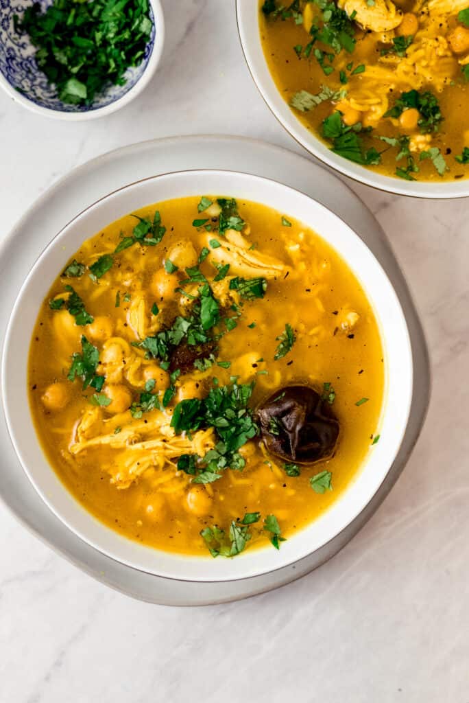 Persian lemon chicken soup is flavored with Persian dried lime and turmeric and full of basmati rice and chickpeas.
