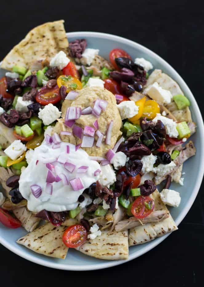 Mediterranean nachos are packed with crunch and layers of flavor. Toasted pita is topped with roasted chicken, hummus and colorful toppings.
