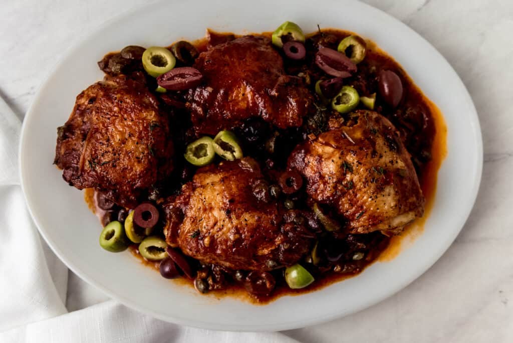 This weeknight chicken puttanesca recipe has chicken thighs that simmer in a bold tomato sauce with olives, capers and Calabrian chiles.