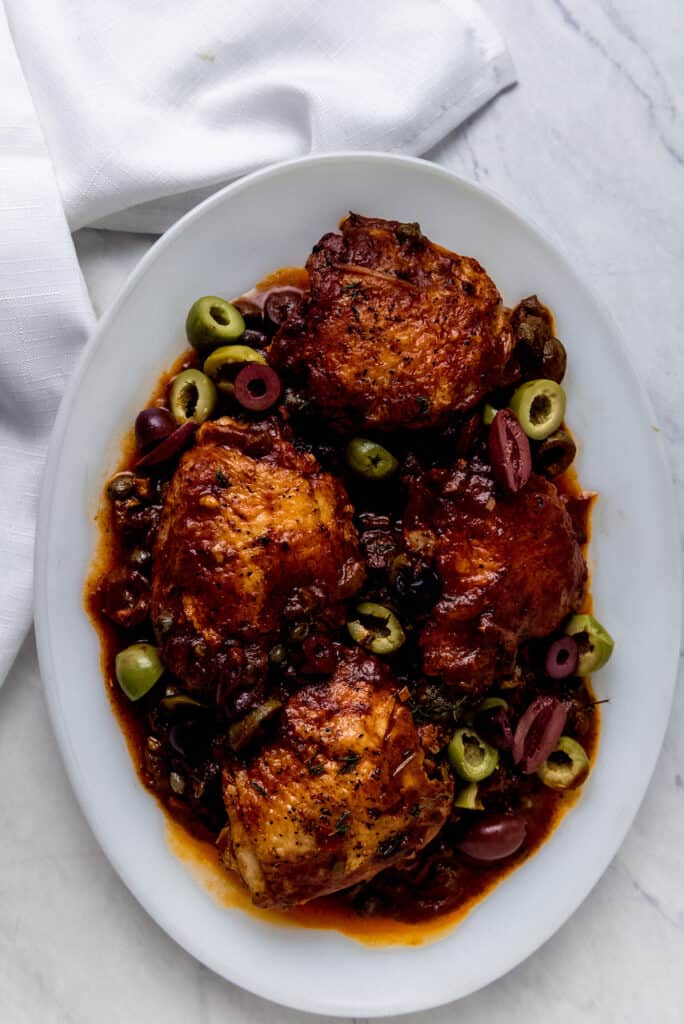 This weeknight chicken puttanesca recipe has chicken thighs that simmer in a bold tomato sauce with olives, capers and Calabrian chiles.