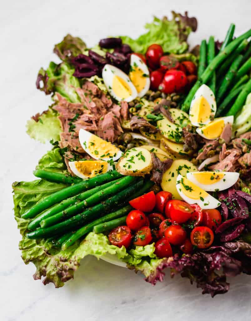 Julia Child's Salad Nicoise recipe is filled with classic components  olives, capers, and fresh vegetables all tossed with a simple vinaigrette. 