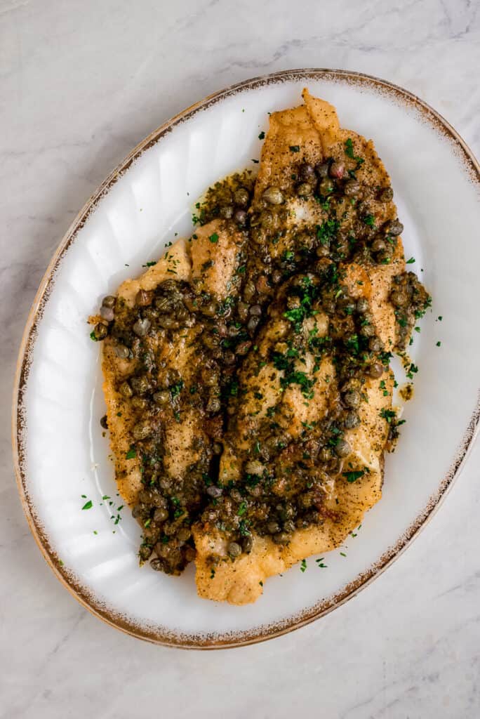 Classic recipe for Julia Child's Sole Meuniere, simply made with lightly breaded fillets of sole and served with a lemony caper butter sauce.