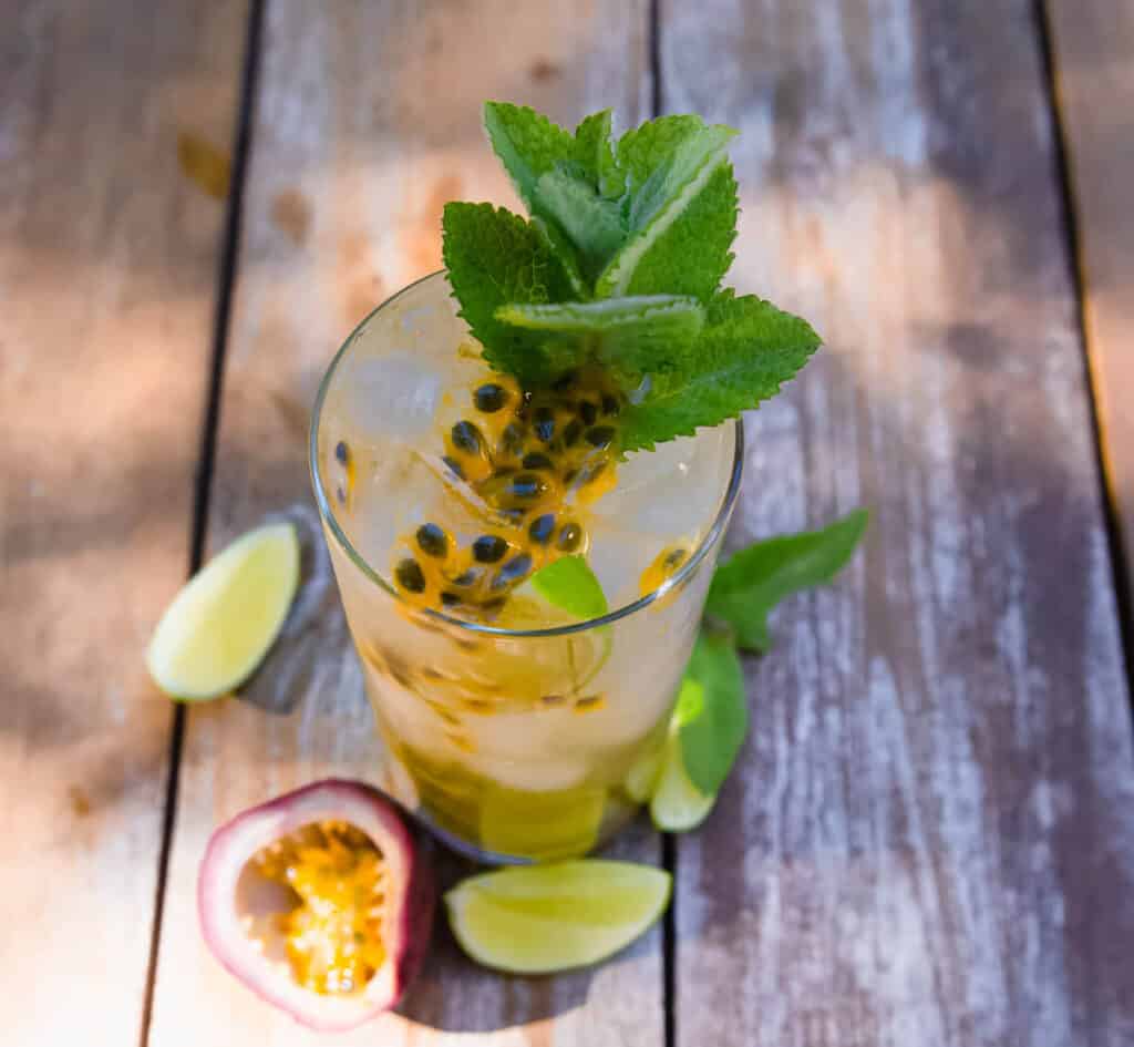 This passion fruit mojito is a muddled with classic flavors of mint and lime and finished with fragrant passion fruit pulp and garnished with more fresh mint.