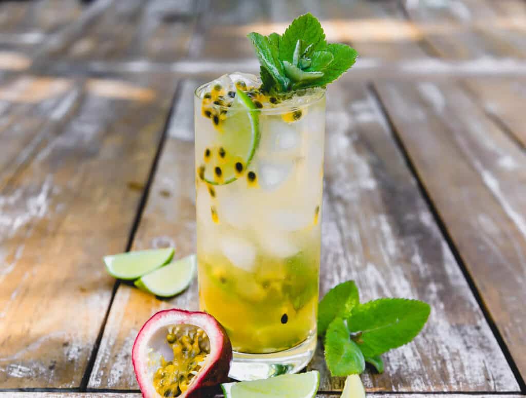 This passion fruit mojito is a muddled with classic flavors of mint and lime and finished with fragrant passion fruit pulp and garnished with more fresh mint.