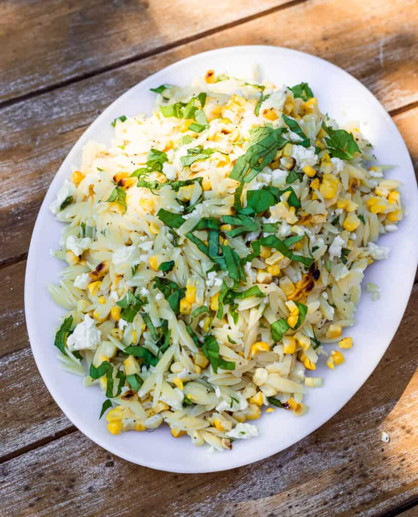 This easy lemon orzo salad comes together quickly! Orzo is tossed with a simple lemon vinaigrette, grilled corn, creamy feta and lots of fresh basil.