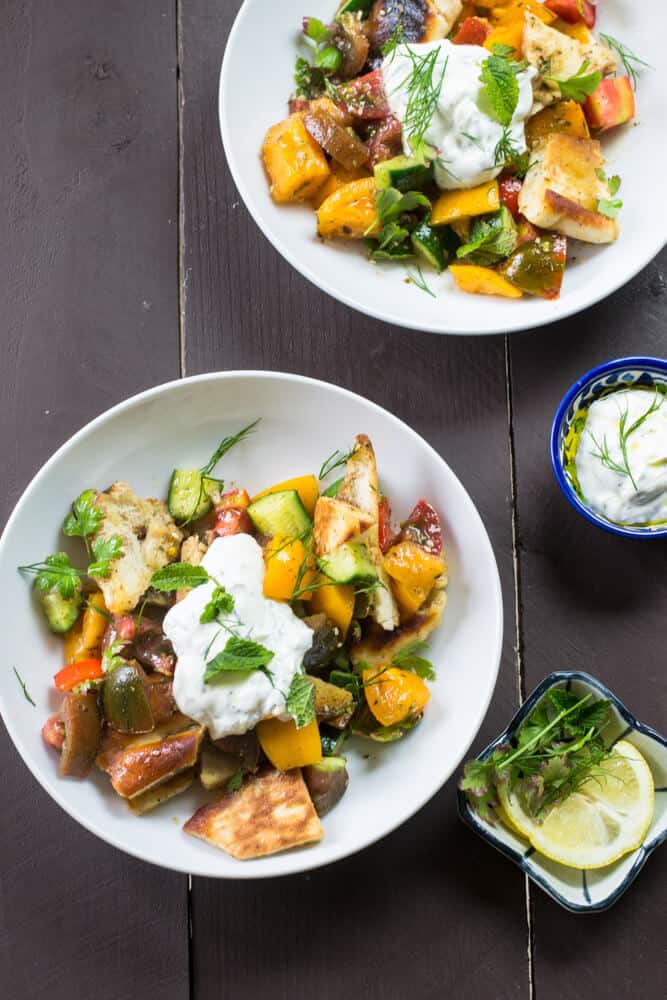  tomato fattoush salad is a gorgeous and robust Mediterranean salad  that is full of colorful heirloom tomatoes, crispy pita chips and dressed with a tangy pomegranate molasses vinaigrette. And for another layer of flavor, topped with a creamy lemon dill yogurt sauce.