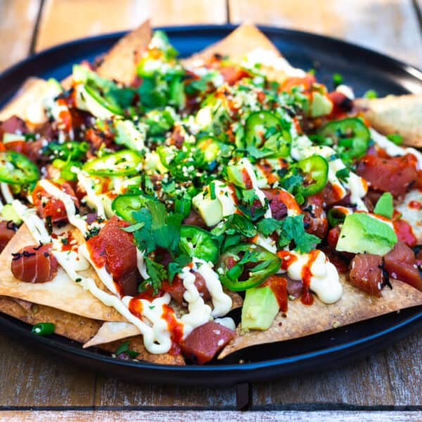 Poke nachos is a fun twist of cultural flavors. Seasoned Ahi poke is layered onto of baked wonton chips and garnished with a drizzle of sriracha, Japanese mayo, cubed avocado, fresh cilantro leaves and thinly sliced jalapeno.
