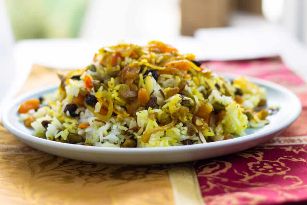 Layer Persian jeweled rice on a wide platter, alternating with the rice and fruit and nut mixture. 
