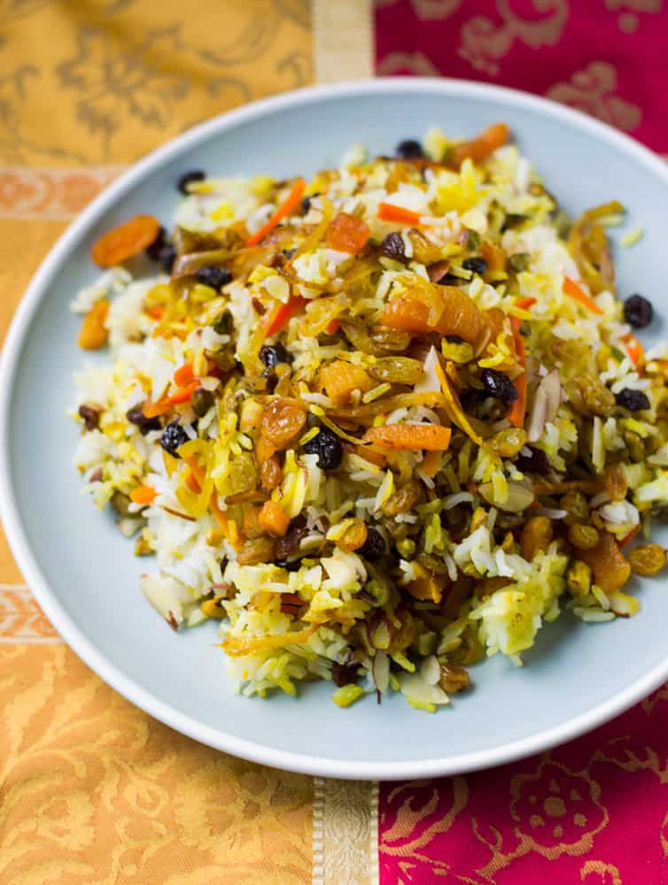 Persian jeweled rice is a colorful Middle eastern rice pilaf with pistachios, slivered almonds, dried fruit, candied orange peel and saffron.