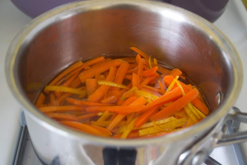 To make the candied orange and carrots, in another small pot, bring 1/2 c sugar and 1/2 c water to a boil. Add orange strips and carrot strips and boil for 15 minutes on low.