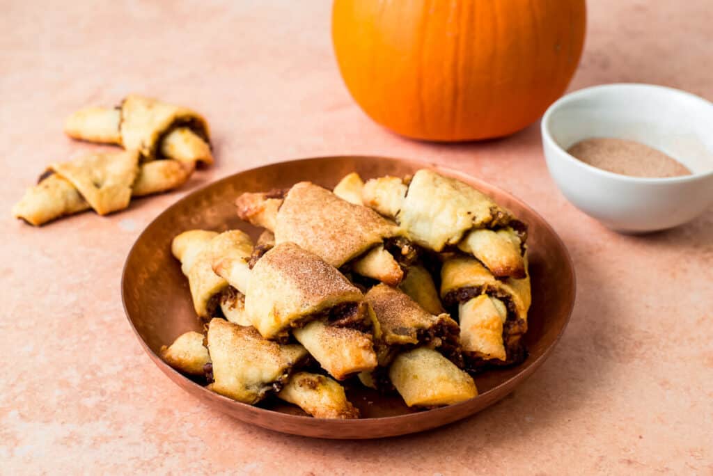 Bake pumpkin rugelach at 350 degrees Fahrenheit for about 20-22 minutes until lightly golden brown. Allow rugelach to cool for at least 10 minutes before serving.