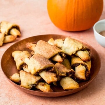 Every year I make a fun new rugelach recipe. I have all sorts of different flavors and fillings. And this year, I am channeling all the fall vibes. Pumpkin rugelach is rolled with sweet candied pecans with warm flavors of cinnamon, cardamom and bright orange zest.