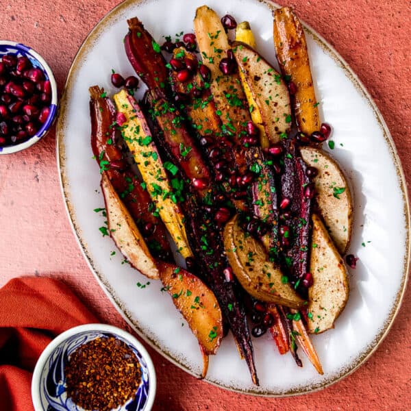 re whisked together with sweet maple syrup and tangy pomegranate molasses and lathered on top of rainbow carrots and sweet anjou pears. Once caramelized, the roasted carrots and pears are finished with pomegranate seeds and Aleppo pepper.