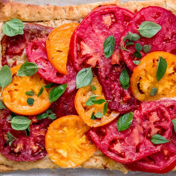 This mascarpone tart is as simple as it gets. Buttery puff pastry is layered with creamy mascarpone cheese, grated Parmesan and slices of sweet heirloom tomatoes. Serve warm or at room temperature for a easy and effortless summer meal.