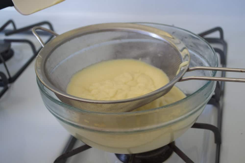 Pass the thickened pastry cream through a fine mesh sieve for an ultra smooth cream.