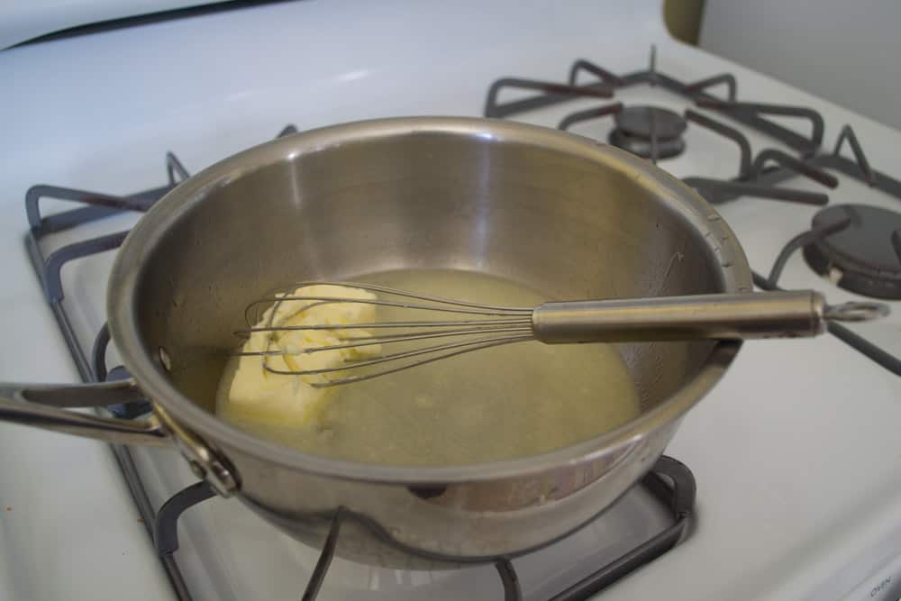 In a medium pot, melt butter, water and salt together. This is the first step in making eclairs.