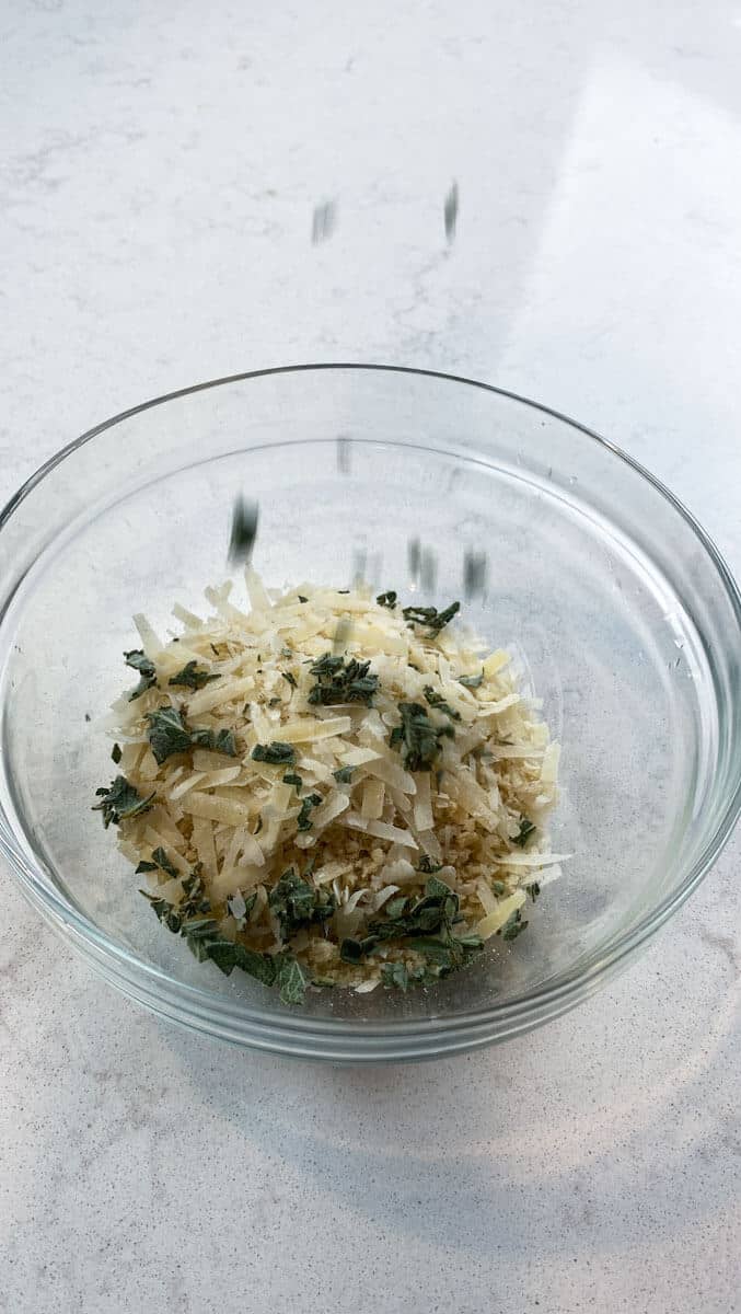 Chopped sage leaves are added to panko and grated Parmesan to be used for roasted delicata squash.