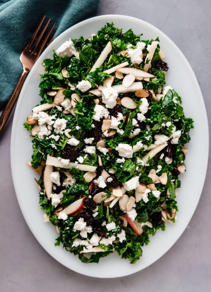 Kale apple salad with crumbled feta cheese and toasted almonds.