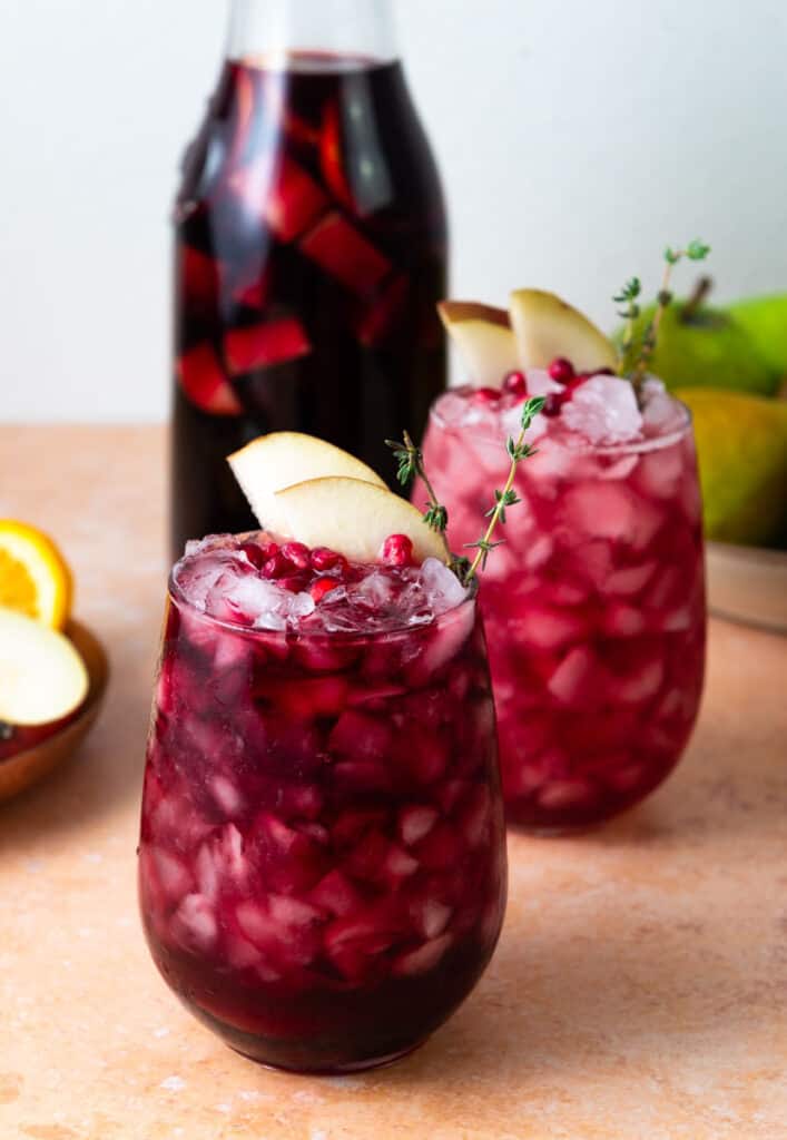Pear and pomegranate red wine sangria in two glasses.