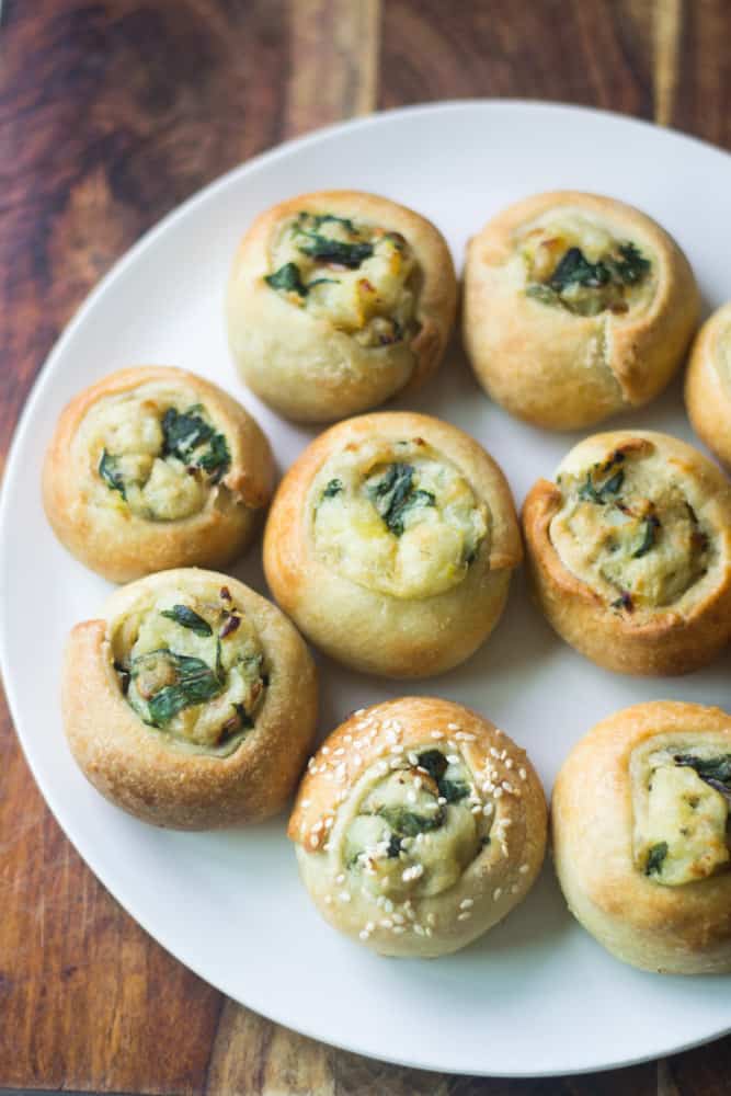 Potato knishes on a plate.