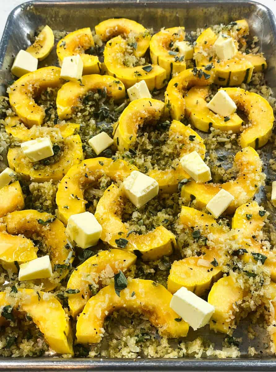 Top the panko coated delicata squash with small cubes of butter before baking