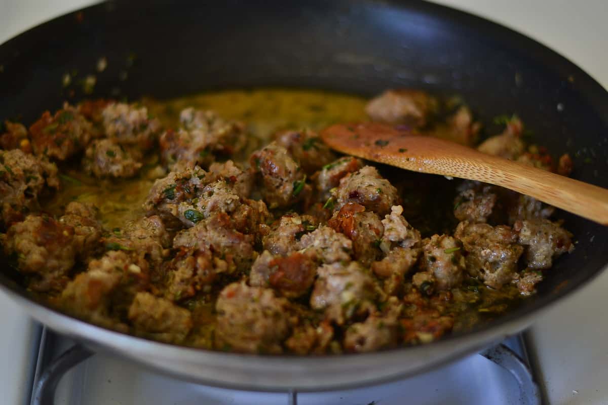 Brown chunks of Italian sausage to add to the savory bread pudding.