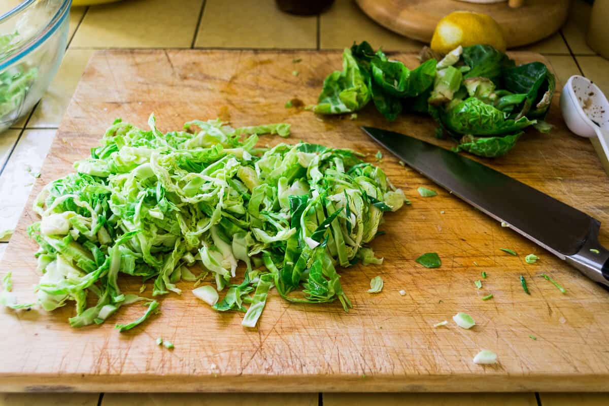 To shave brussels sprouts, but them in half and slice to make thin shreds.