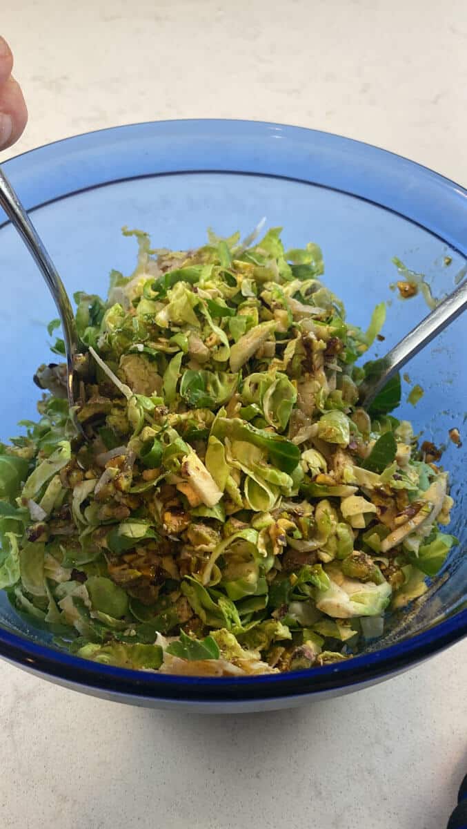 Toss the shredded brussels sprouts salad with the pistachios, parmesan and dressing. 