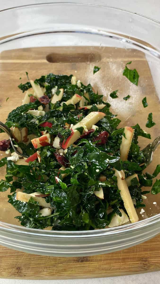 Toss the kale and cranberry salad together in a large bowl.