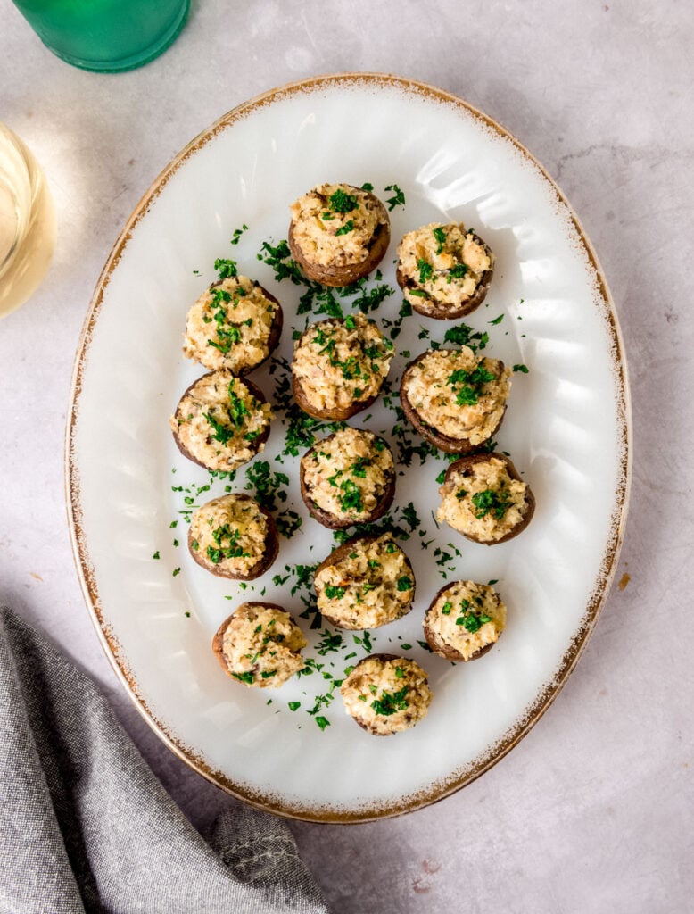 Boursin stuffed mushrooms on a white platter.