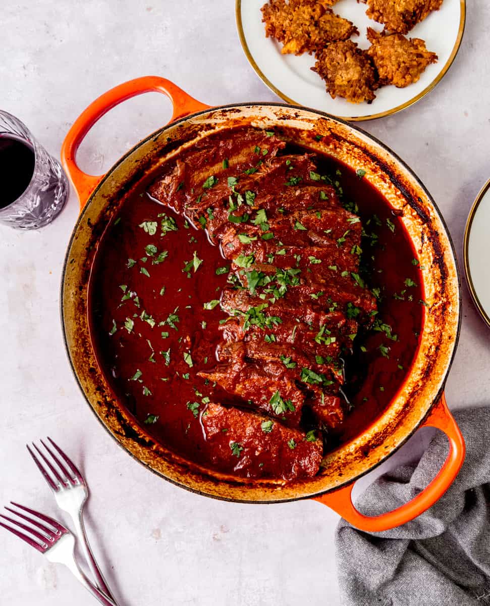 Braised Jewish style brisket sliced and placed back in the dutch oven with a rich sweet and sour sauce.