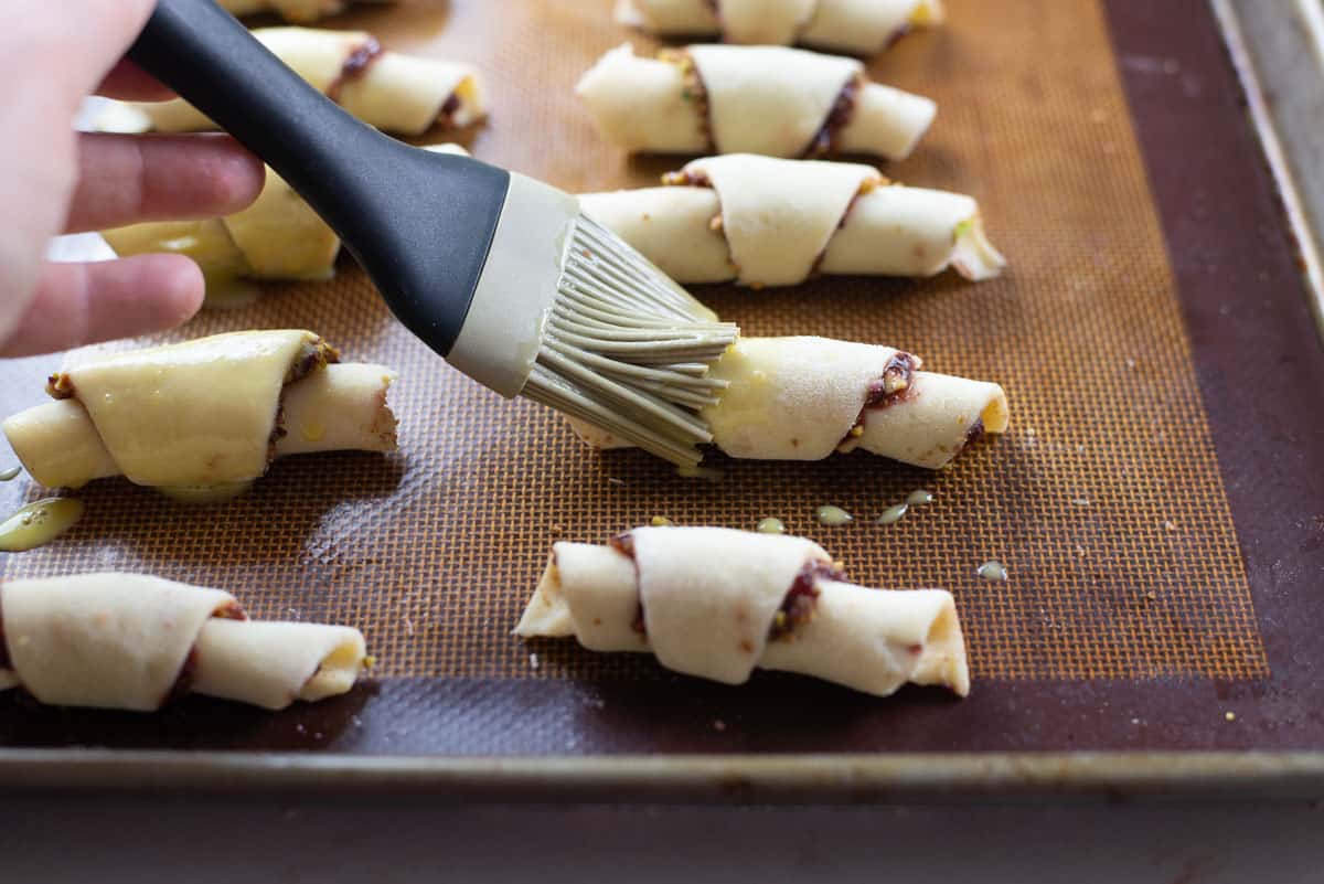 Brush rugelach with egg wash and place on a cookie sheet before baking.