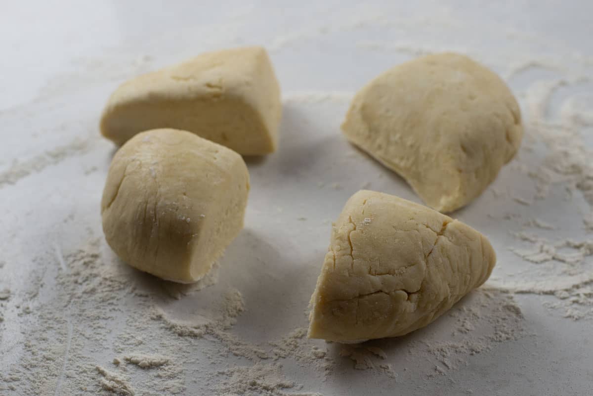 Cut the rugelach dough into quarters.