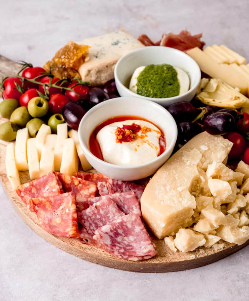 Italian meat and cheese board with salami and Parmesan.