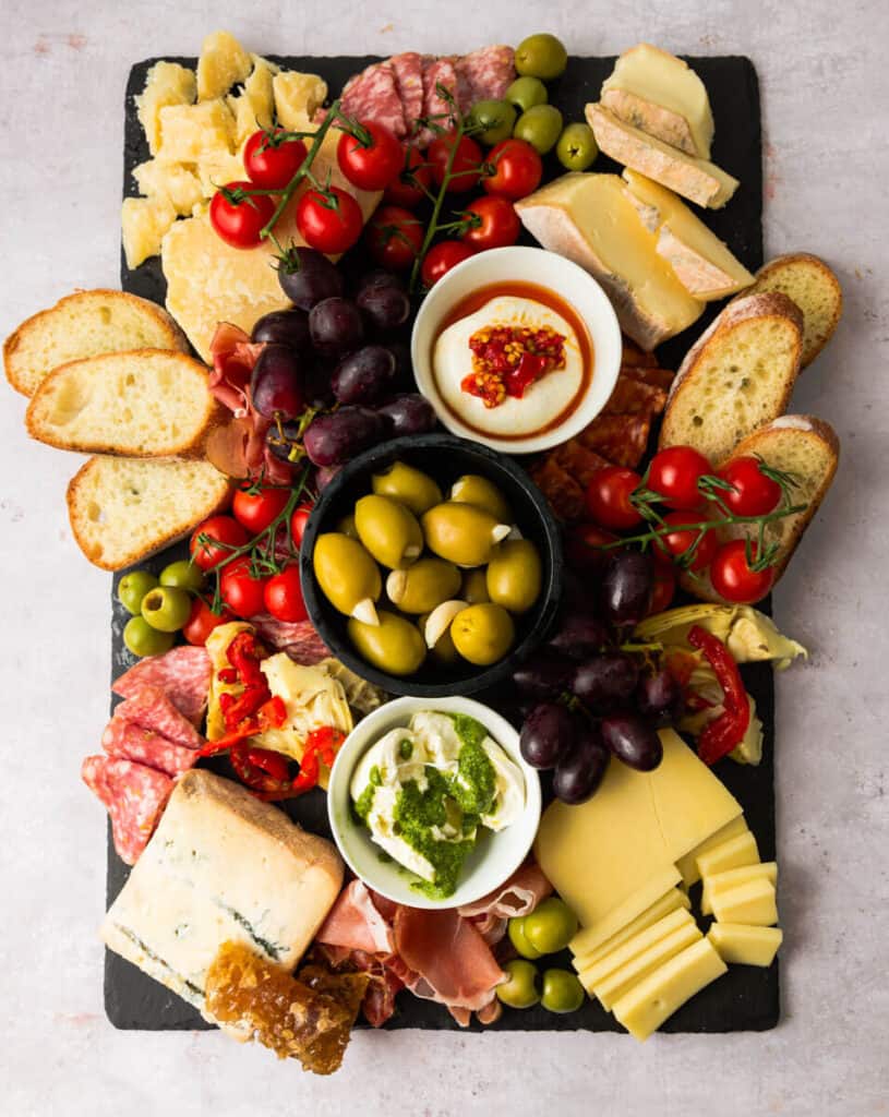 Large Italian charcuterie board with meats and cheeses.