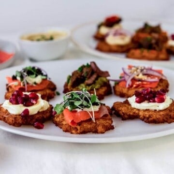 Crispy potato latkes with different toppings, including salmon, creme fraiche and guacamole.