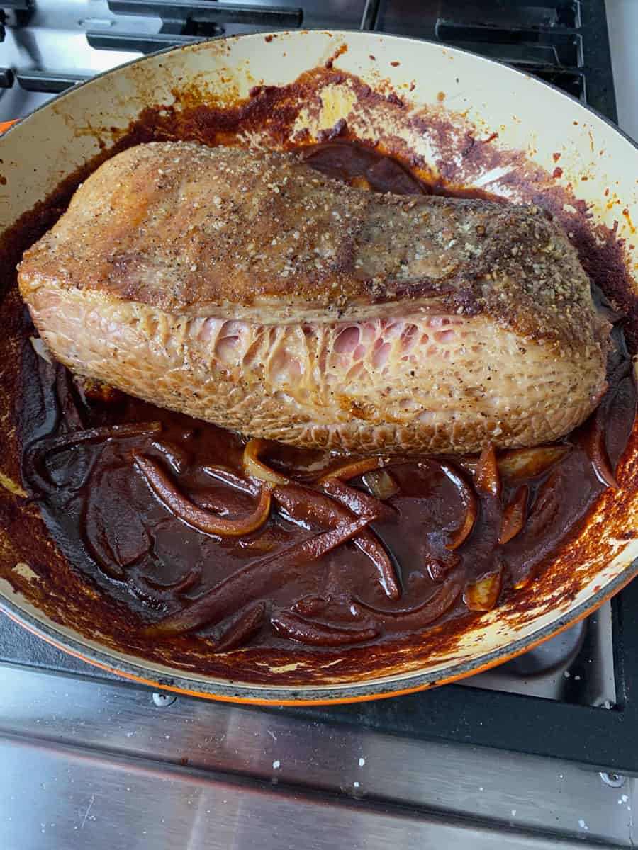 Add the seared brisket back into the dutch oven with the reduced wine sauce.