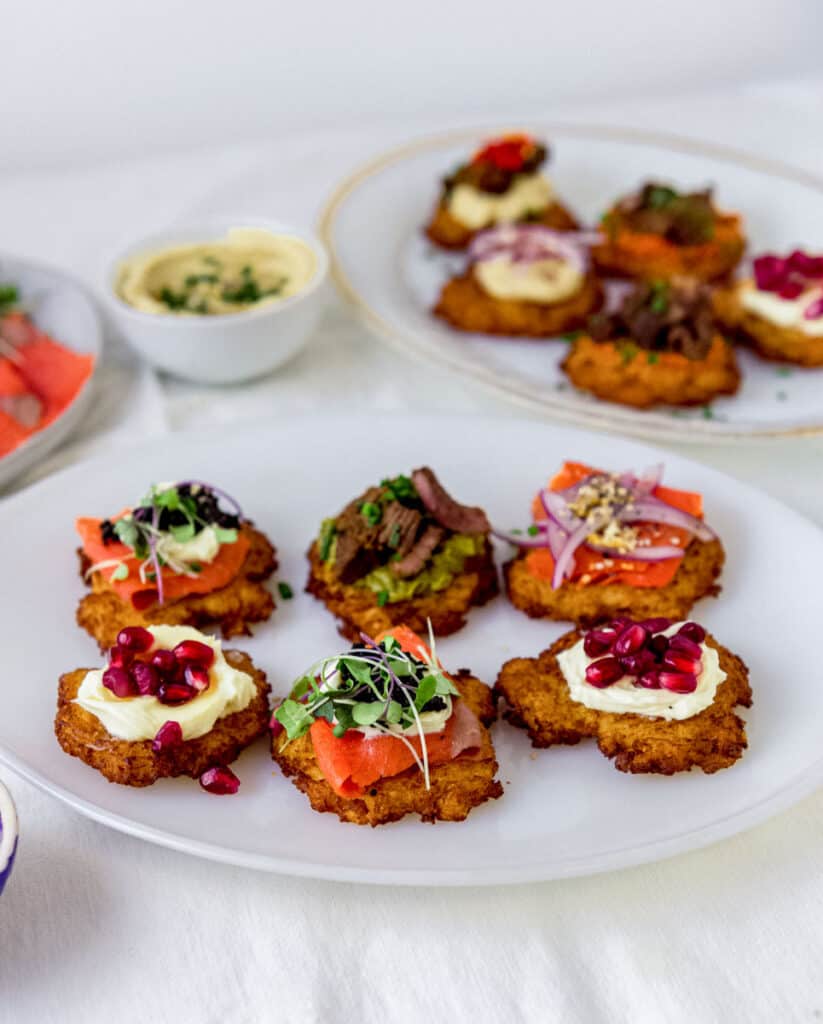 Platter of latkes with all sorts of toppings to serve at a latke party!