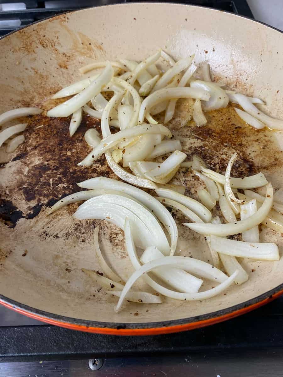 Saute sliced onions in the same dutch oven for a few minutes to soften.