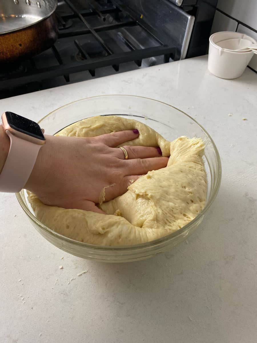 Once the donut dough has risen, gently punch the dough down.