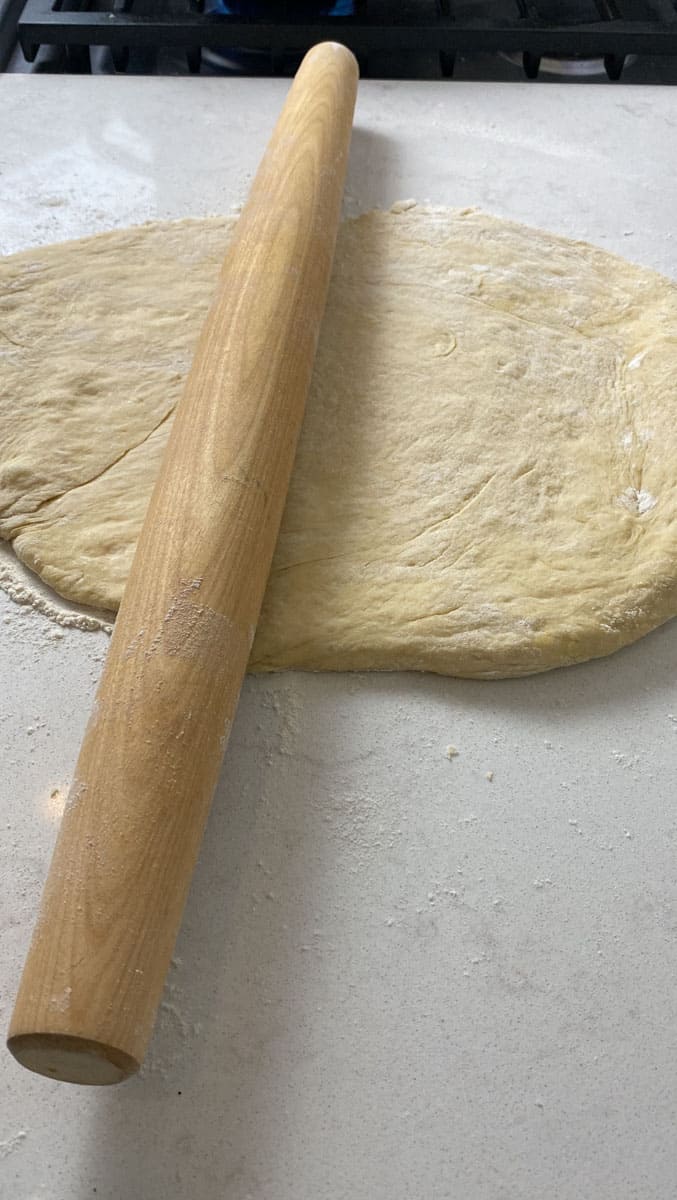 Transfer the donut dough to a lightly floured surface and roll out to 1/2 inch thickness.
