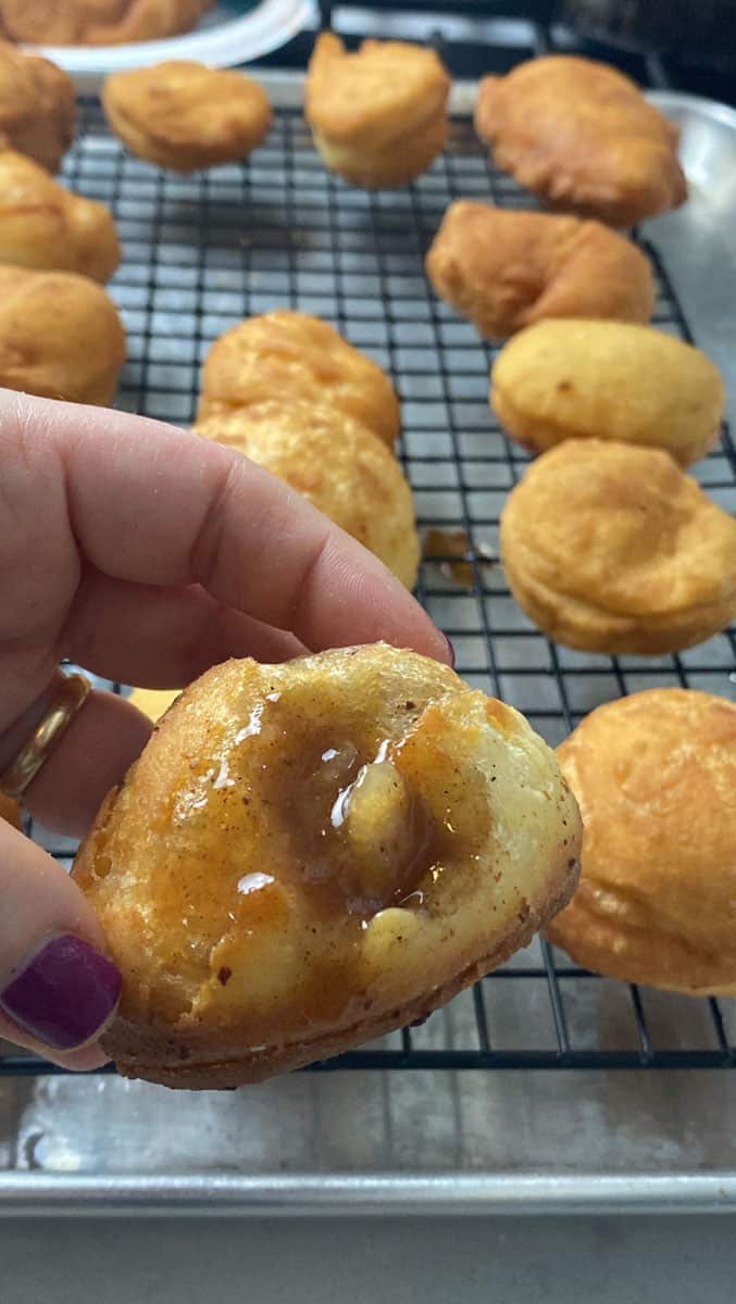 Fill fried donut balls with cooked pear filling.