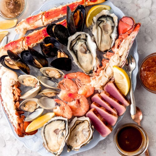 Assemble the best seafood platter with chilled clams, oysters, seared tuna and crab legs.