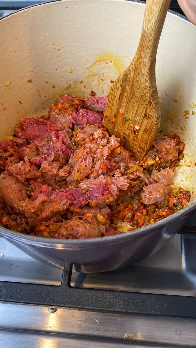Add ground beef and pork and use a sturdy spoon to break up the meat.