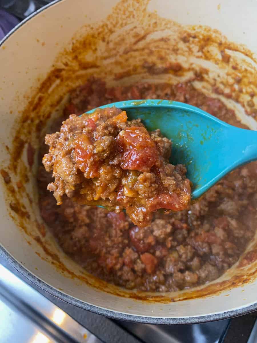 Cook the bolognese sauce until thickened.
